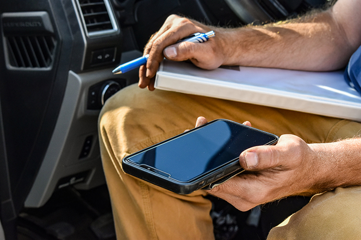 Person with mobile phone in a vehicle
